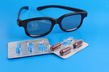 Vitamin complex capsules to improve vision and glasses. Prevention and treatment of eye diseases.