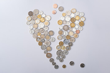 heart-shaped arrangement crafted from coins originating from different countries, with each coin...