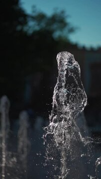 city fountain with splashing jet of clean transparent water, slow motion