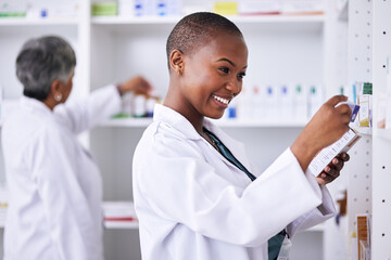 Happy black woman, pharmacist and pills for inventory inspection or checking stock on shelf at pharmacy. African female person in medical healthcare with pharmaceutical product for medication storage - obrazy, fototapety, plakaty