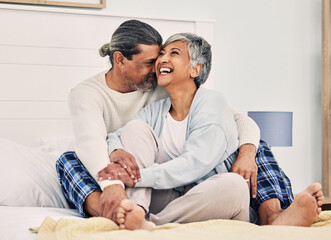 Hug, funny or old couple in bed to relax, enjoy romance or morning time together at home in retirement. Embrace, senior woman or happy elderly man laughing or bonding with love, support or smile