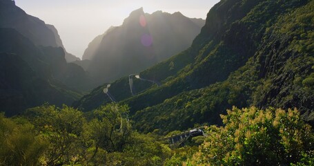 Spring nature in Masca Valley and Gorge in Tenerife, Canary Islands, Spain. Warm sunset light glow. Sunlight breaks through the mountain ranges. Amazing view.