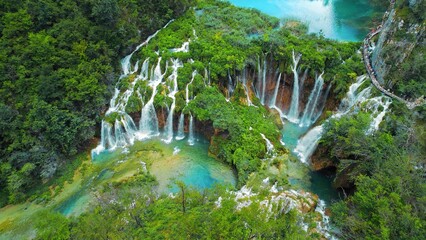 Fototapeta premium Plitvice waterfalls in Croatia. Mountain streams flow into a lake with azure clear water. Summer National Park.
