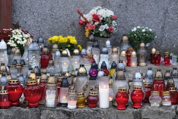 A lot of colorful lit candles standing at the memorial site