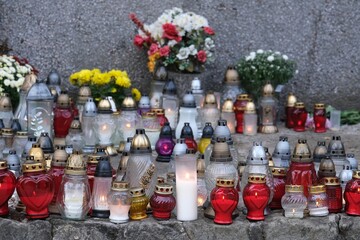 A lot of colorful lit candles standing at the memorial site