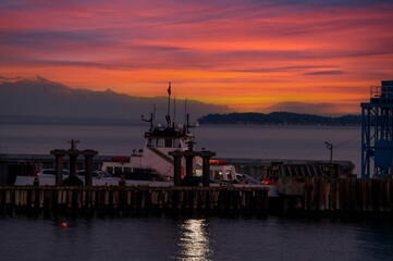 Ferry boat docking at an island in the Salish Sea during a dramatic sunrise. The Whatcom Chief...