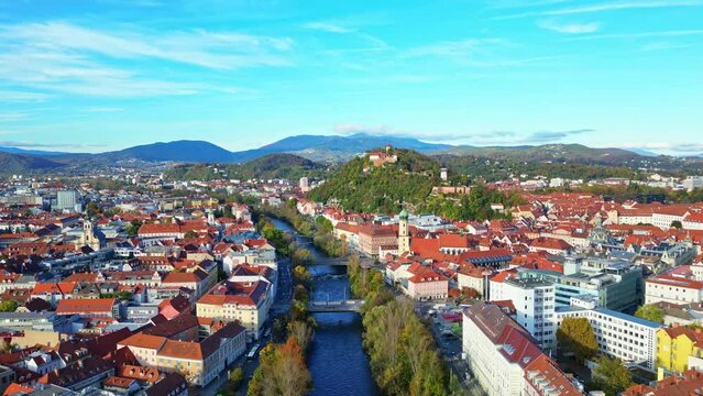 Aerial flight over the roofs of the historic city centre of Graz in Austria on a beautiful autumn evening	
