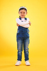 Arms crossed, angry and portrait of girl child in studio with bad, attitude or behavior problem on yellow background. Frown, face and asian kid with body language for no, frustrated or tantrum emoji - obrazy, fototapety, plakaty