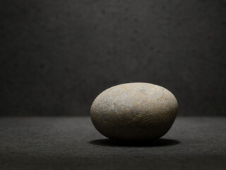 Fototapeta na wymiar zen stones for the podium on a dark background