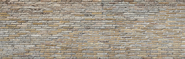 An old fence or wall of a building constructed from shell rock or sandstone blocks. Texture or pattern