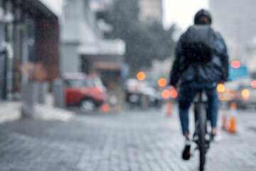 Cyclist, bicycle and delivery in the city on rainy day or cold weather in an urban town on mockup....