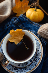 Cozy autumn morning breakfast in bed, still life. There is a cup of hot coffee and tea by the window. Autumn, Thanksgiving concept. White pumpkins and yellow leaves on a wool blanket.