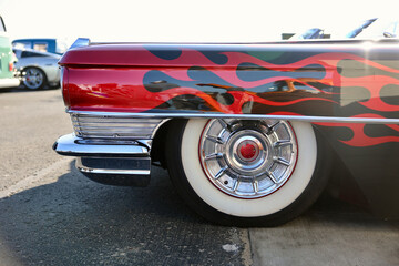 side view of 1960s vintage car with red flames