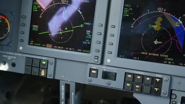 Close up shot of aircraft instruments being arranged on contol panel of private jet Hawker 750. Both PFD and MFD presenting flight information