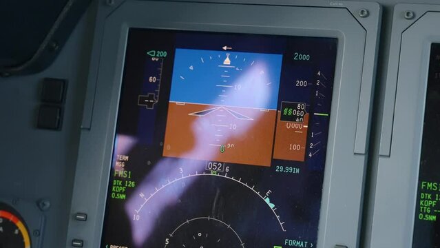 Boom up shot of pilot's primary flight display inside luxurious jet Hawker 750. PFD replacing artificial horzon while showing calibrated airspeed, altitude, heading, and yaw