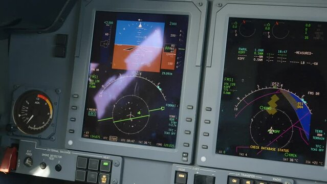 Tracking shot of pilot's main displays and warning system inside private jet cockpit. Hawker 750 demonstrating advanced avionics for luxury passenger aircraft