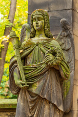 Fototapeta premium Historic Statue on the autumn mystery old Prague Cemetery, Czech Republic