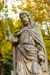 Fototapeta premium Historic Statue on the autumn mystery old Prague Cemetery, Czech Republic