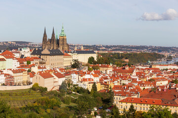 Fototapeta premium Autumn Prague City with gothic Castle, colorful Nature and Trees with blue Sky from the Hill Petrin, Czech Republic
