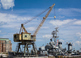 Fototapeta na wymiar Portal crane with the background of USS Cassin Young at Charlestown Navy Yard dry dock, Boston, MA, USA