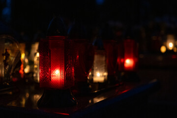 Candle light in the cemetery at night. Selective focus.All saint's day.  Lanterns in the cemetery...