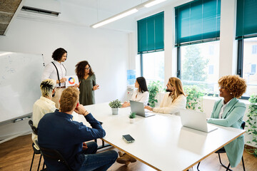 Coworkers showing a graphic during a meeting