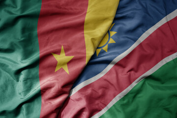 big waving national colorful flag of cameroon and national flag of namibia .