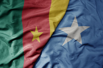 big waving national colorful flag of cameroon and national flag of somalia .