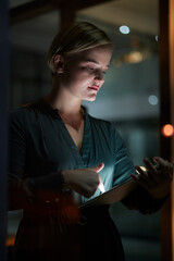 Dark, tablet and woman is working overtime in late in the evening in a modern office for a startup...