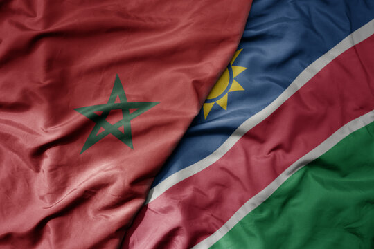 big waving national colorful flag of morocco and national flag of namibia .