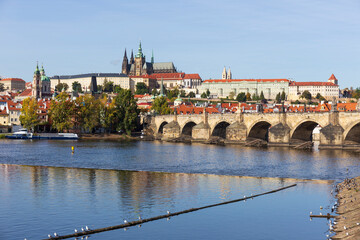Obraz premium Autumn colorful Prague Lesser Town with gothic Castle above River Vltava in the sunny Day, Czech Republic