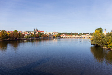 Fototapeta na wymiar Autumn colorful Prague Lesser Town with gothic Castle above River Vltava in the sunny Day, Czech Republic