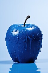 blue apple with water drops on a blue background 