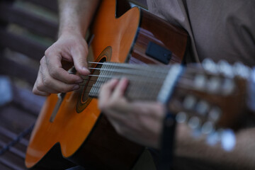 the person who plays a classical guitar. tomorrow's detail that uses a musical instrument....