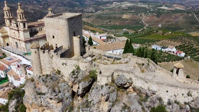 The small Spanish town of Olvera in Andalucia with white washed buildings, a hilltop castle and cathedral