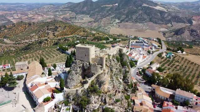 The small Spanish town of Olvera in Andalucia with white washed buildings, a hilltop castle and cathedral