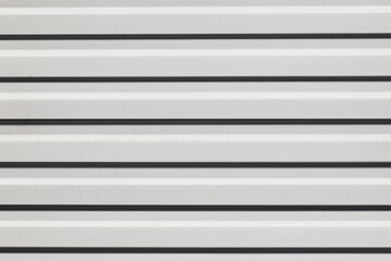 Obraz premium Corrugated metal sheet background. White paint metal stripes. Striped pattern. Garage door. Geometric lines metal wall.
