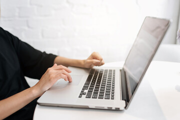 Close up woman's hands typing on laptop keyboard at home office. Businesswoman or student girl using pc for online internet marketing, freelance, work from home, education online, distance studying