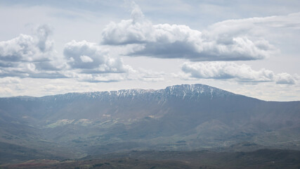 View of a snow covered Suva planina (Dry mountain) ridge and Trem summit under a hazy sky - 671855919