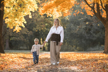 Mothers day, love family.  Family on autumn walk in nature outdoors. Mother and child with hugging tenderness