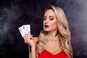 Photo of adorable successful lady wear sexy outfit playing cards casino isolated dark black color background
