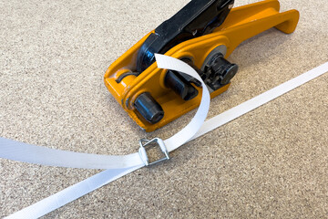 Manual packaging of cargo for shipping. Hand-operated polypropylene strapping tool. Packaging and...