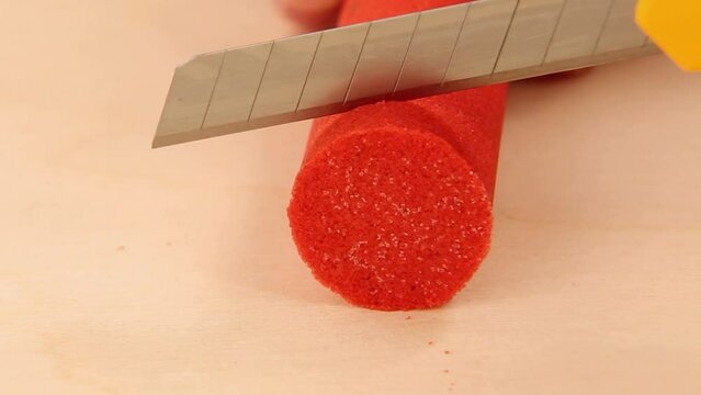 Red, kinetic sand is cut into round pieces. Satisfactory ASMR videos. Soothing