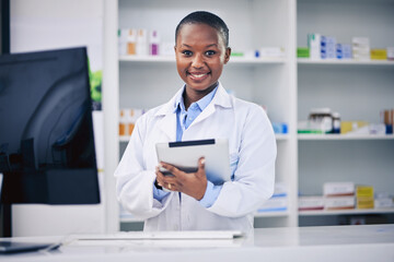 Black woman, tablet and pharmacist with checklist at counter for medicine stock, info and advice on...