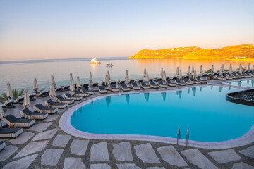 Blue Pool near the building on a background of blue sky and sea in Greece.