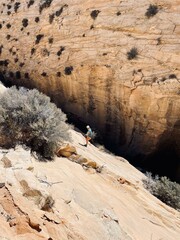 Woman rappelling into canyon