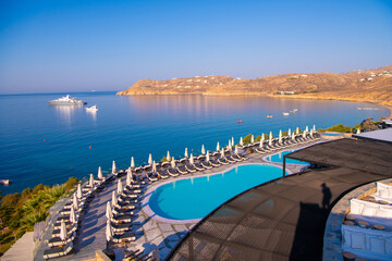 Blue Pool near the building on a background of blue sky and sea in Greece.