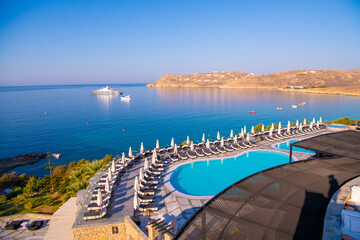 Blue Pool near the building on a background of blue sky and sea in Greece.