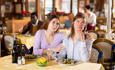 Quarrel of two friends during dinner in a restaurant