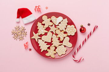Obraz na płótnie Canvas Cute homemade Christmas cookies with decor on color background,top view